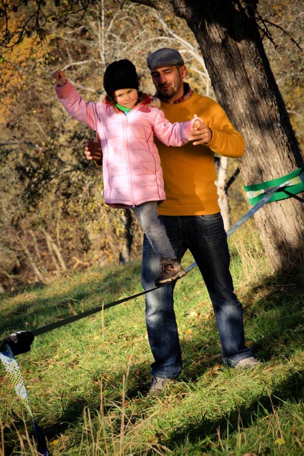 Gibbon-Slacklines-Fun-Line-girl-learns-with-father--how-to-slackline