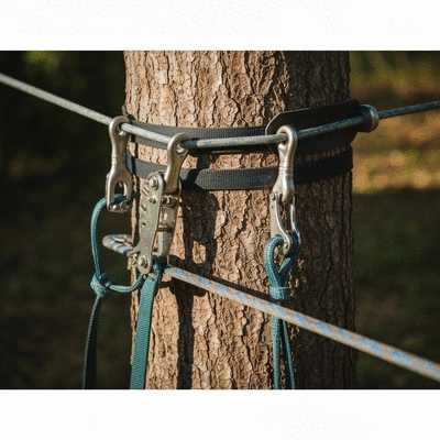 Close-up of slackline equipment setup with anchors and webbing